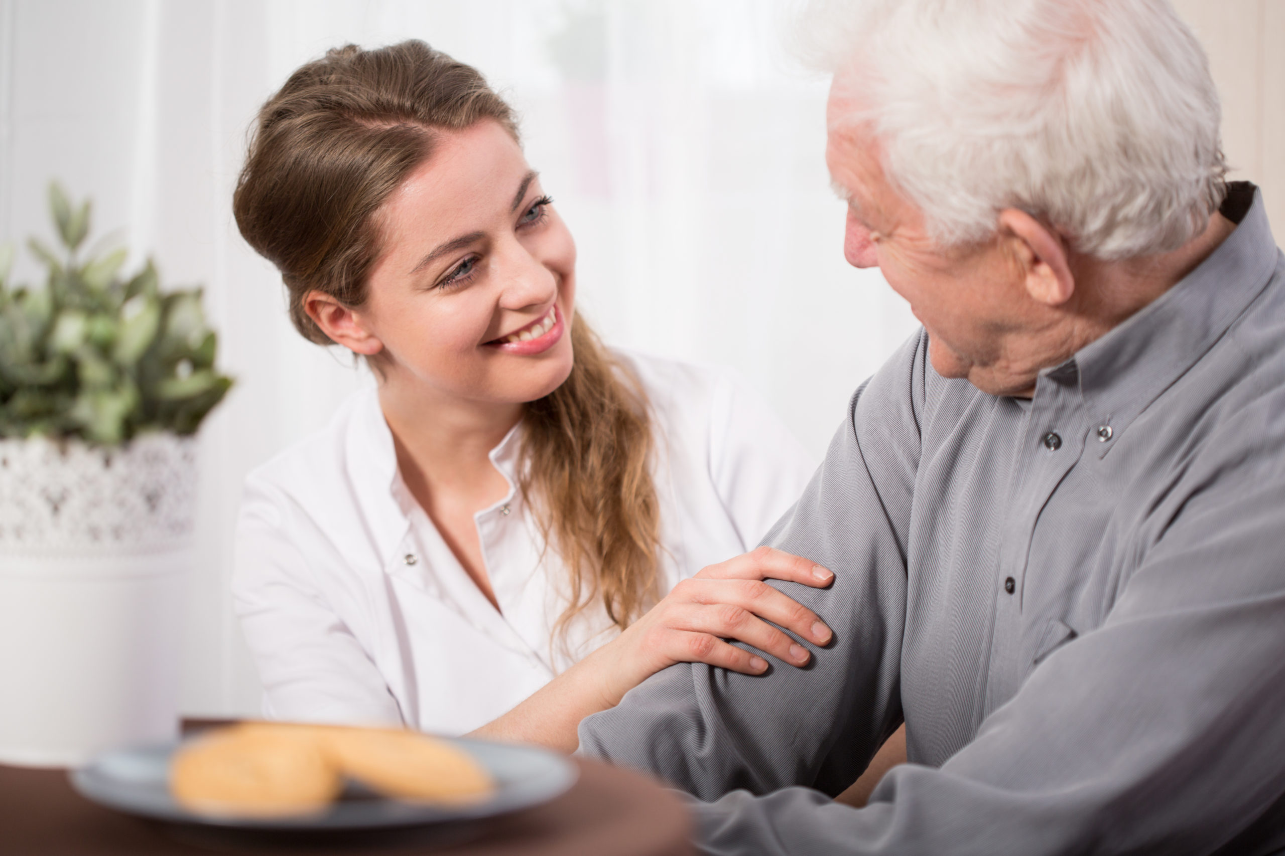 Female Nurse Helping Elderly man manage emotions