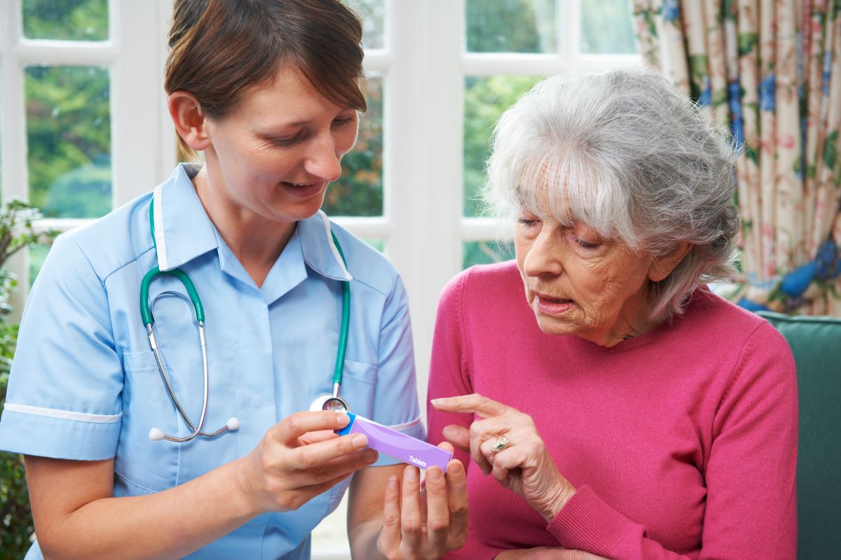 photo of nurse discussing psychotropic medications with resident for psychotropic stewardship webinar
