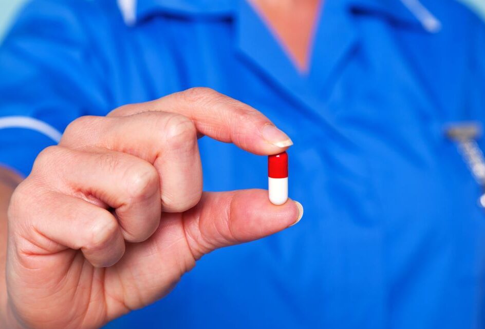 nurse holding pill
