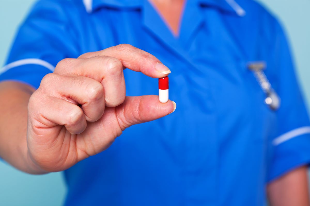 nurse holding pill