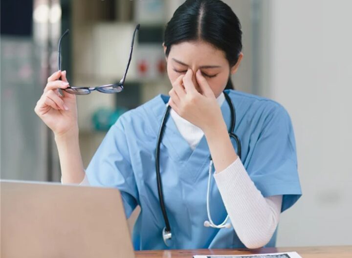 female health care worker experiencing stress, burnout