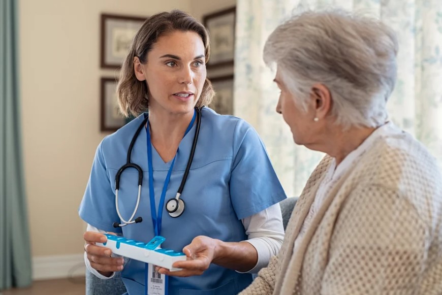 nurse reviewing medication with senior woman