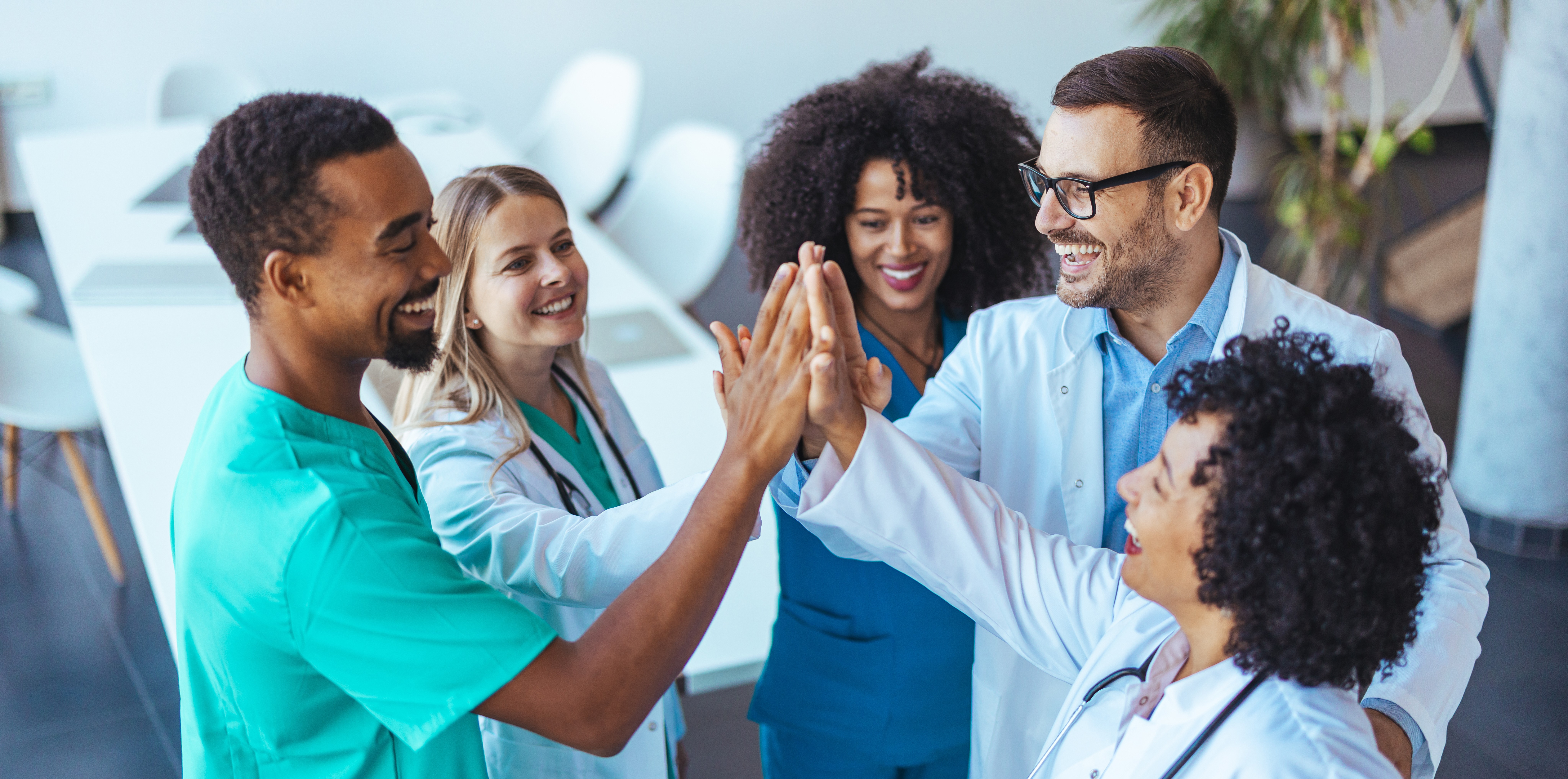 health care professionals high fiving